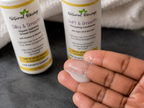 Little Miracles shampoo and conditioner bottles with conditioner texture shown on fingertips