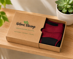 Burgundy menstrual panties on tabletop with packaging.