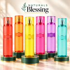 Naturals Blessing six-bottle body mist collection on an emerald pedestal